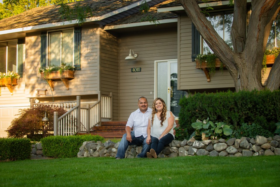 Members sitting in front of a home